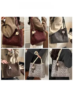 Detail of leopard print tote bags in four colors with woven handles and plush charms