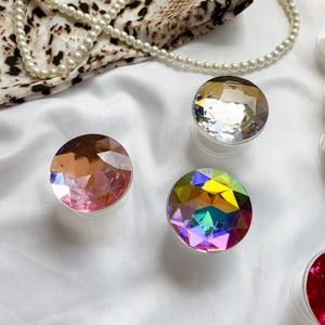 Detailed view of three luxury gemstone phone grips in champagne, clear, and AB colors