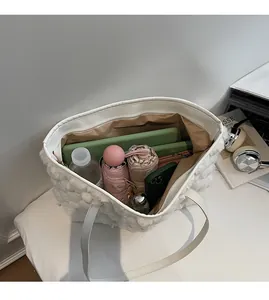 Detailed view of the spacious interior of this white plush faux fur tote bag