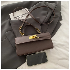 Detail of dark brown leather handbag with gold twist lock and phone for size reference
