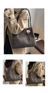 Close-up of leopard print tote bag with green woven handle and cute plush charm
