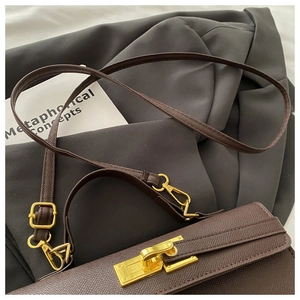 Close-up of brown litchi grain leather bag with vintage golden metal twist lock detail