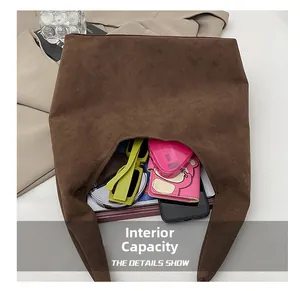 Detail view of large interior capacity for a brown suede tote bag with daily items