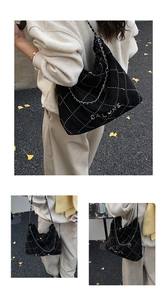 Detail of black quilted shoulder bag featuring silver chain strap and large capacity