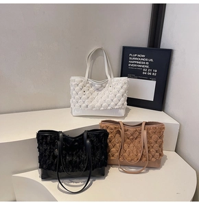 Detailed close-up of textured plush tote bags in white, black, and brown with leather straps