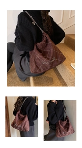 Detailed close-up of brown suede bag with diamond stitching and gold metal chain strap