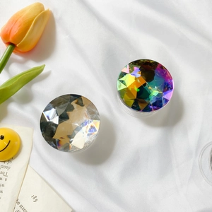 Detail of faceted crystal phone grip with iridescent laser finish and silver texture