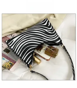 Internal view of zebra print shoulder bag showing space for phone and accessories