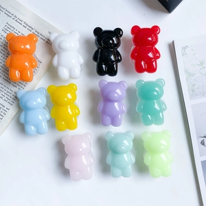 Set of 11 colorful 3D gummy bear cell phone expanding sockets on a white surface