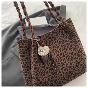 Detail of leopard print tote bag with woven leather handle and ice cream charm
