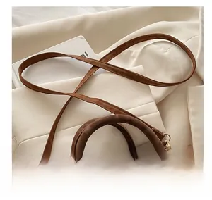 Detail of adjustable leather strap and polished hardware on brown vintage tote bag