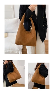 Detail of a large brown hobo shoulder bag in frosted matte finish for commuting