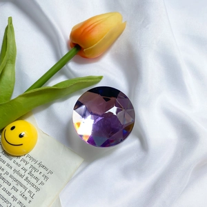 Detailed view of a purple geometric faceted crystal cell phone expanding grip stand