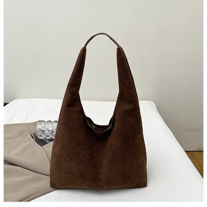 Detailed view of the dark brown suede tote bag featuring a premium matte texture