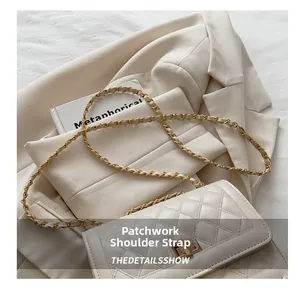 Detail of the quilted beige bag featuring a spliced metal chain and leather strap