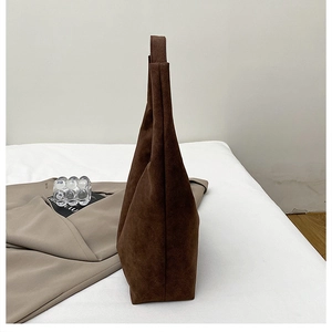 Side view of dark brown suede tote bag showing large capacity and soft minimalist silhouette