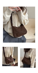 Detail of leopard print tote bag with brown adjustable strap and durable zipper closure
