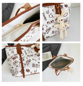 Detailansichten einer Canvas-Tragetasche mit Graffiti-Print, Reißverschluss und Hase