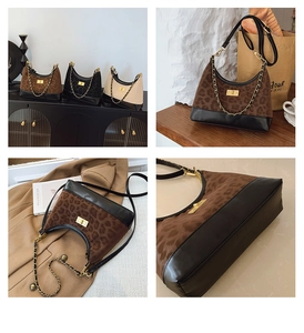 Detail view of stylish leopard print shoulder bag with chain strap and gold clasp lock