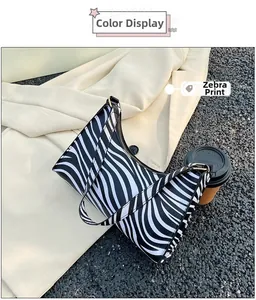 Outdoor shot of a zebra print hobo bag highlighting the black and white pattern detail