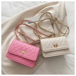 Detail of pink and beige quilted chain bags with gold twist locks and woven straps
