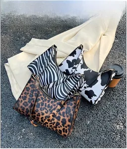 Detailed comparison of animal print baguette bags in leopard, zebra, and cow patterns
