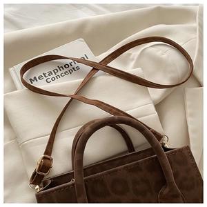 Detail of leopard print tote bag with soft suede texture and adjustable shoulder strap