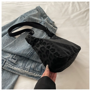 Close-up of leopard print nylon chest bag with adjustable strap and metal zipper