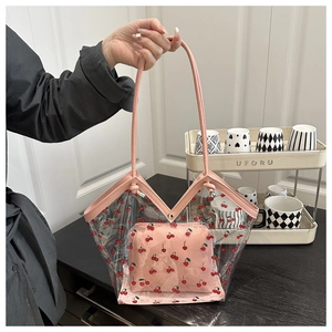 Dettaglio della borsa tote in PVC trasparente con stampa ciliegie e pochette rosa