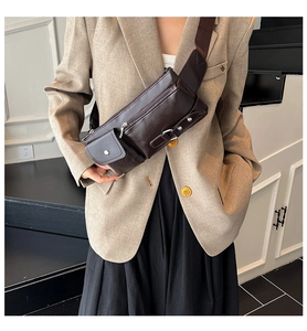 Detail shot of vintage dark brown pebble leather sling bag with functional multi-pockets