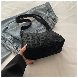 Close-up of leopard print underarm bag with adjustable wide fabric shoulder strap