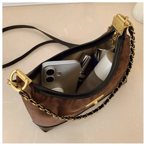 Top view of retro brown shoulder bag showing spacious interior with luxury gold hardware
