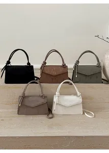 Minimalist corduroy flap handbags in five colors displayed on stone steps detail