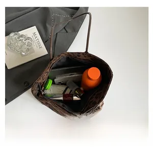 Top view of leopard print tote bag interior showing capacity for laptop and daily essentials