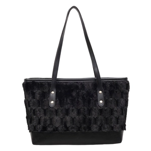 Fashionable black tote bag with plush textured top and smooth leather base for daily commute