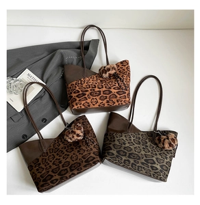 Three leopard print tote bags with brown leather handles and plush ball charms