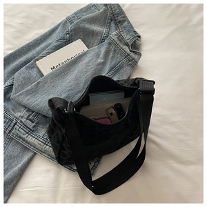 Detail view of the spacious interior of the black leopard print hobo shoulder bag
