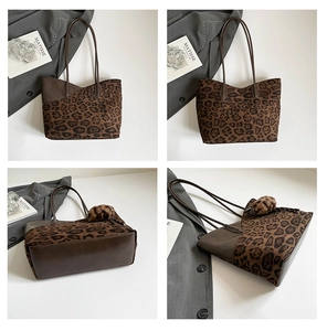 Detail view of large leopard print tote bag with dark brown leather straps and fuzzy pompom