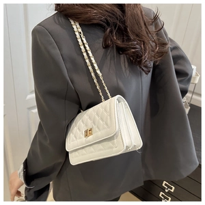 Detail of white quilted leather crossbody bag with gold chain and turn-lock closure