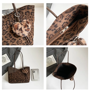 Detail view of large leopard print tote bag with plush heart charm and zipper system