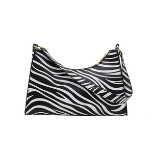 Chic zebra pattern baguette bag with gold zipper and shoulder strap on white background