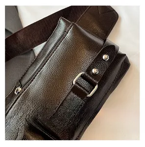 Close-up of retro brown lychee grain leather crossbody bag with silver metal rivets