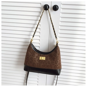 Detail of leopard print crossbody bag with gold chain strap and metal lock closure