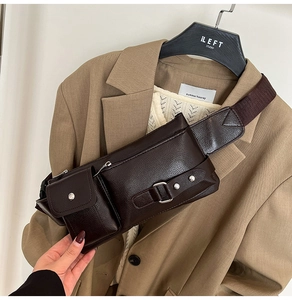 Detail of dark brown leather crossbody bag featuring multiple pockets and silver buckles