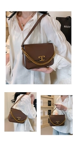 Close-up of brown leather crossbody bag with gold chain and double T metal lock