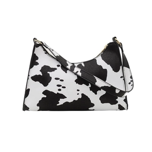 Chic underarm baguette bag with black and white cow print and gold metal ring detail