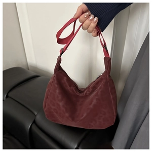 Detail of burgundy leopard print nylon crescent bag with adjustable shoulder strap