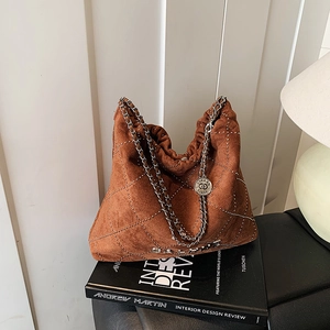 Deep brown quilted suede tote bag with silver metal chain and micro-stud detailing