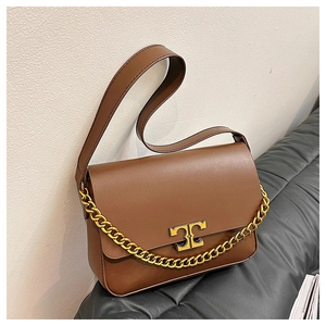 Close-up of brown leather shoulder bag featuring a gold T-bar magnetic clasp and chain