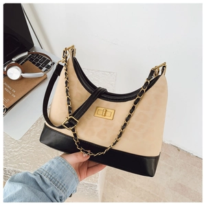 Detail of leopard print underarm bag with gold twist lock and black leather trim